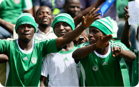 Nigeria football fans cheering in the stadium during a match.