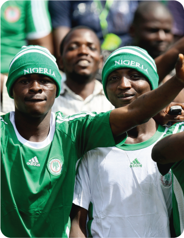 Nigeria football fans cheering in the stadium during a match.