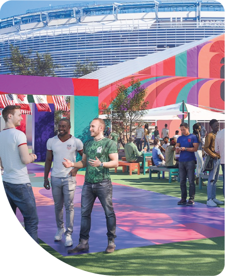 Visitors enjoying an outdoor FIFA World Cup 2026 hospitality lounge with visible branding.