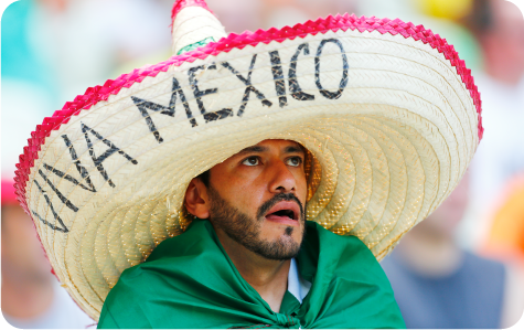 Mexican football fan wearing a giant ‘Viva Mexico’ sombrero inside the stadium.