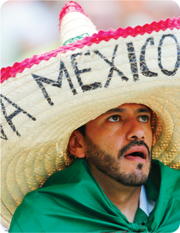 Mexican football fan wearing a giant ‘Viva Mexico’ sombrero inside the stadium.