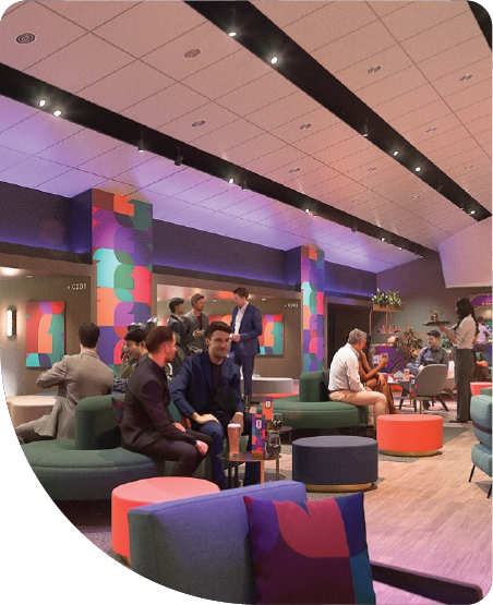 Guests seated in a spacious FIFA World Cup 2026 hospitality lounge with official branding.